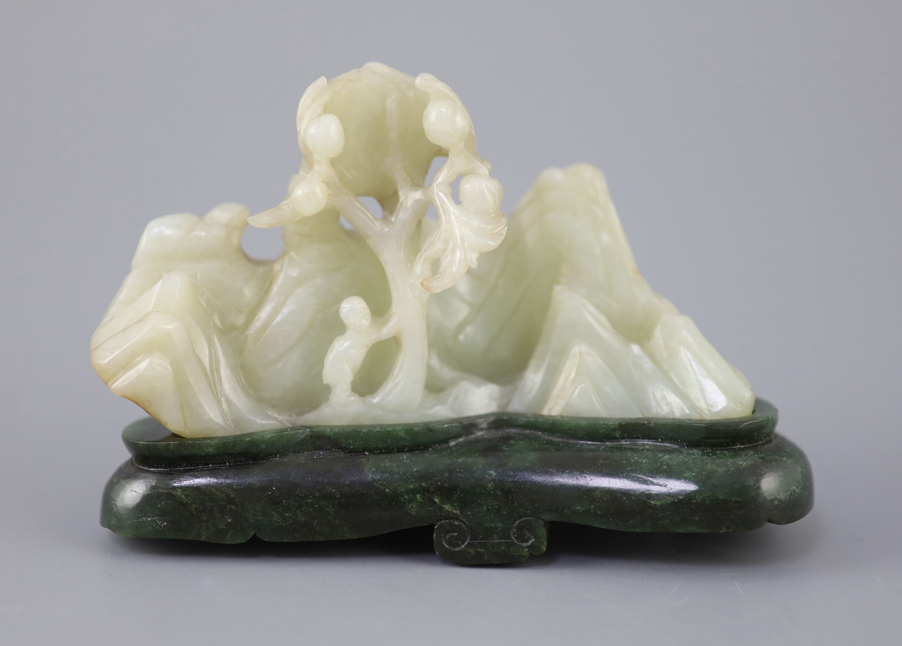 A Chinese pale celadon jade boulder carving, Qing dynasty, 13cm wide, the spinach green jade stand probably later
